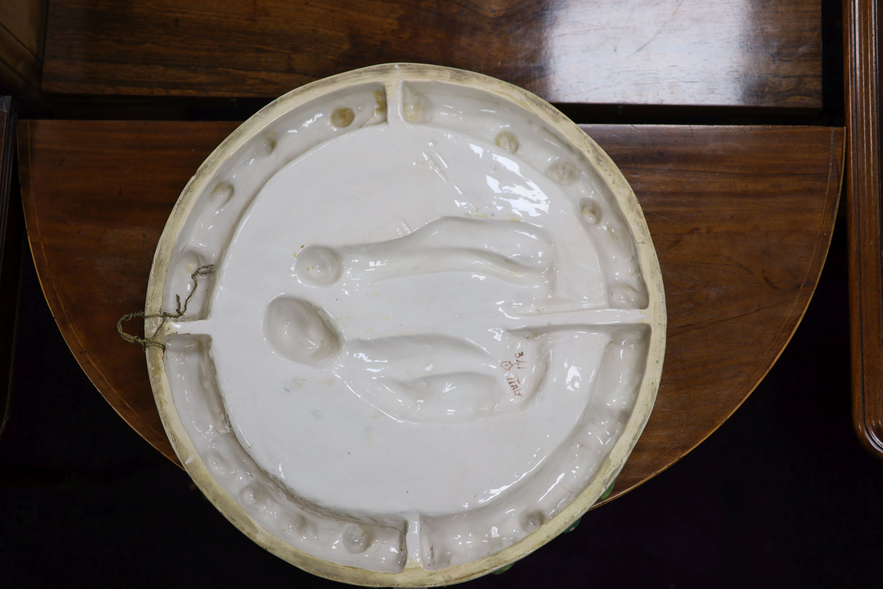 A Della Robbia type roundel, Madonna and Child